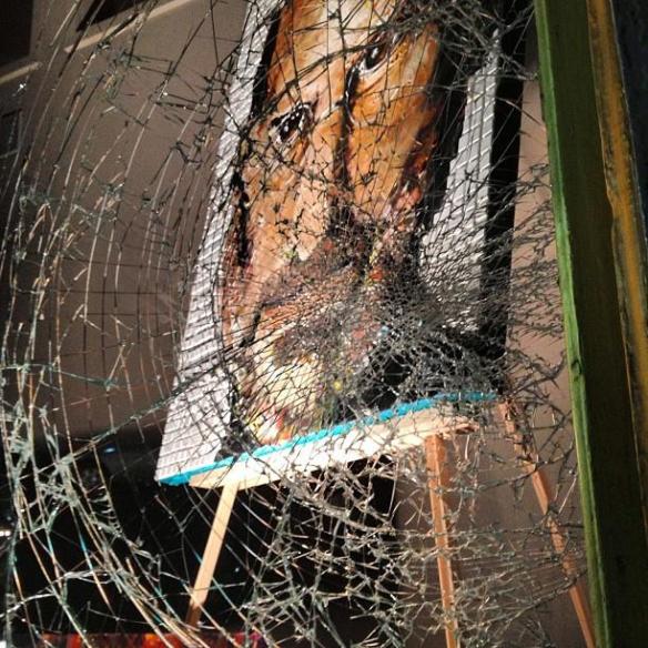 Photo of Steve Jobs painting behind the shattered glass in Cincinnati, Ohio